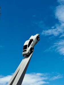 a white car on top of a tall pole